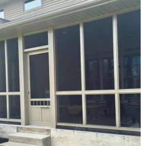tan vinyl screen enclosure surrounding a porch, offering insect protection and all-weather outdoor comfort